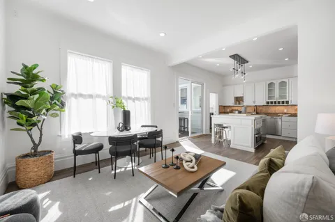 a dining room with furniture and wooden floor