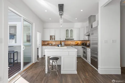 a kitchen with a table chairs stove and cabinets