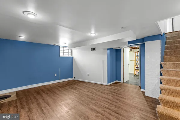 a view of room with stairs and wooden floor