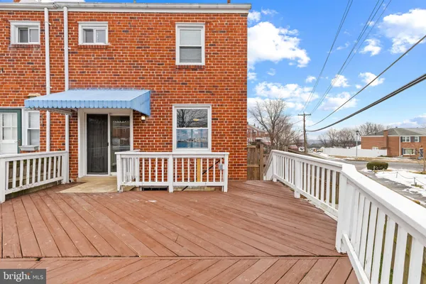 a view of a house with a wooden deck