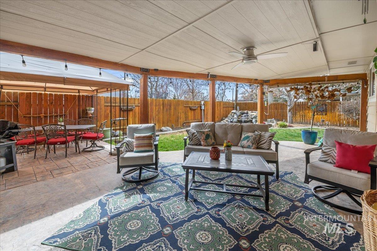 712 Southwest 4th Street Fruitland, ID 83619 - Photo 1 of 21 Fenced backyard with outdoor lounge area, a patio, and ceiling fan