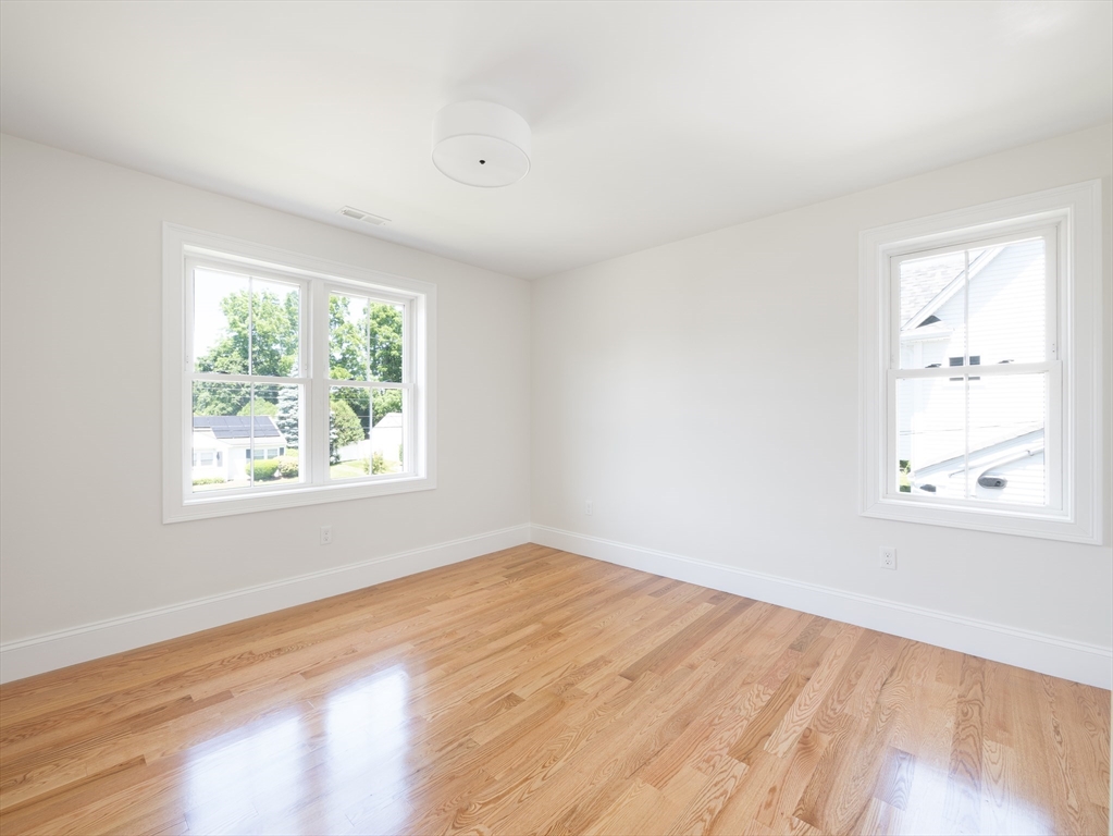 5 Stanley Street Natick, MA 01760 - Photo 13 of 21 an empty room with wooden floor and windows