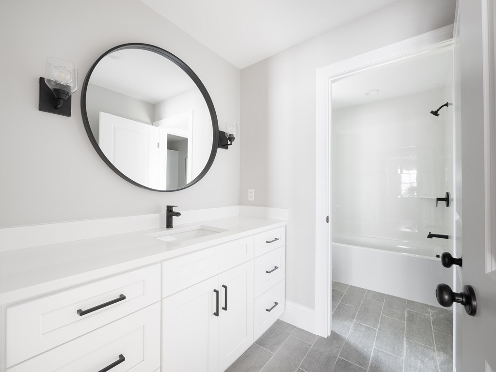 5 Stanley Street Natick, MA 01760 - Photo 16 of 21 a bathroom with a sink and a mirror