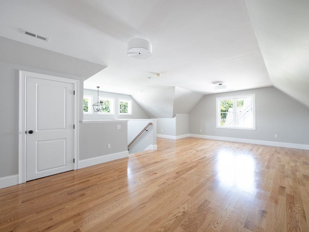 5 Stanley Street Natick, MA 01760 - Photo 17 of 21 an empty room with wooden floor cabinet and windows