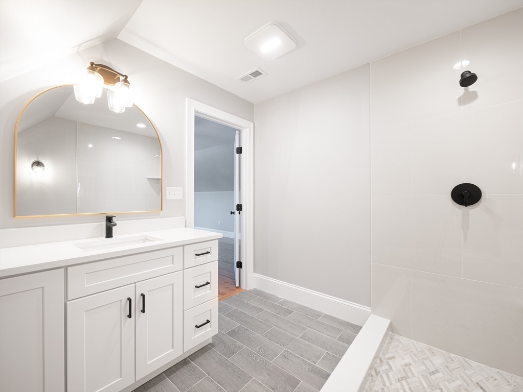 5 Stanley Street Natick, MA 01760 - Photo 18 of 21 a spacious bathroom with a double vanity sink a mirror and shower