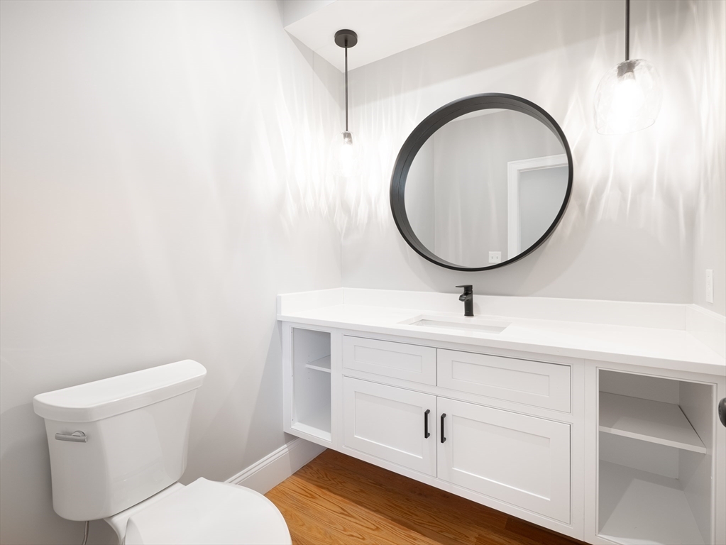 5 Stanley Street Natick, MA 01760 - Photo 19 of 21 a bathroom with a toilet a sink and a mirror