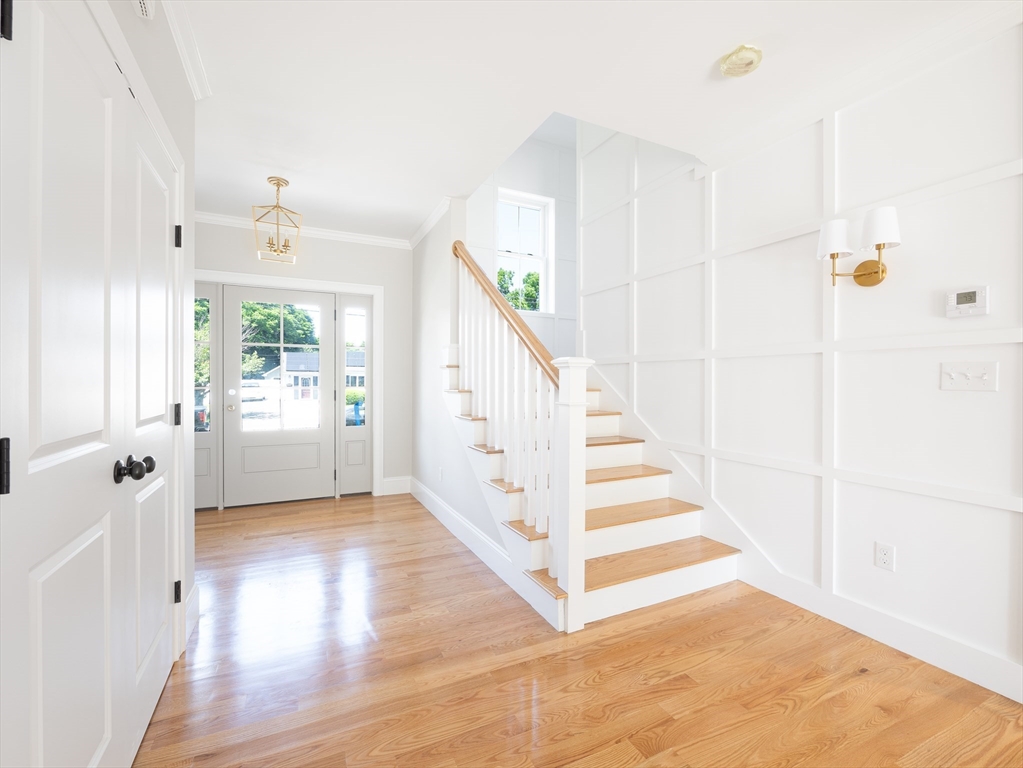 5 Stanley Street Natick, MA 01760 - Photo 5 of 21 a view of a hallway with wooden floor and staircase