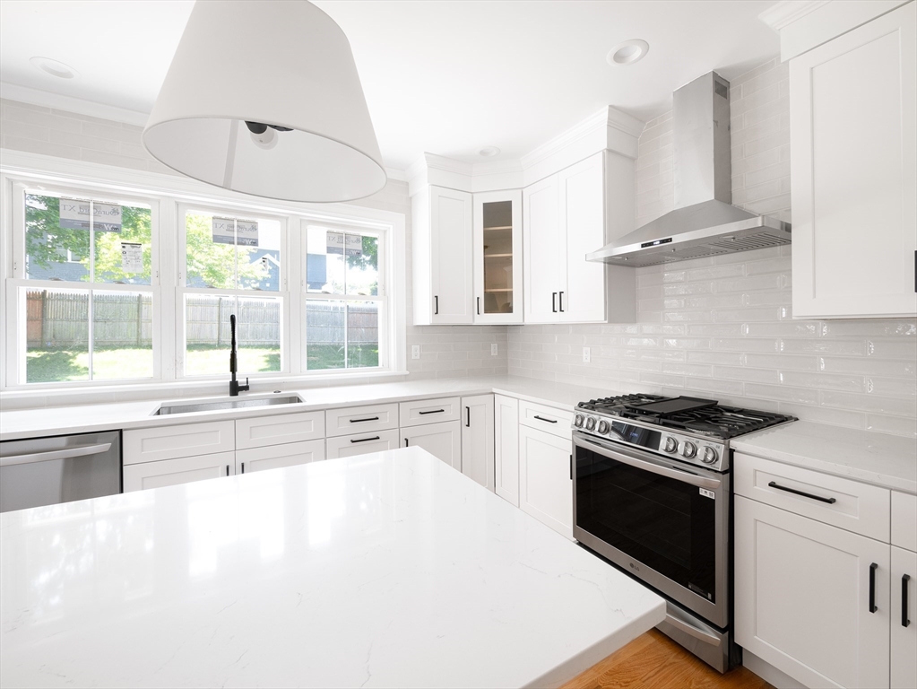 5 Stanley Street Natick, MA 01760 - Photo 7 of 21 a kitchen with stainless steel appliances white cabinets and a stove