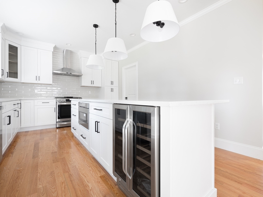 5 Stanley Street Natick, MA 01760 - Photo 8 of 21 a kitchen with stainless steel appliances a stove a sink and white cabinets