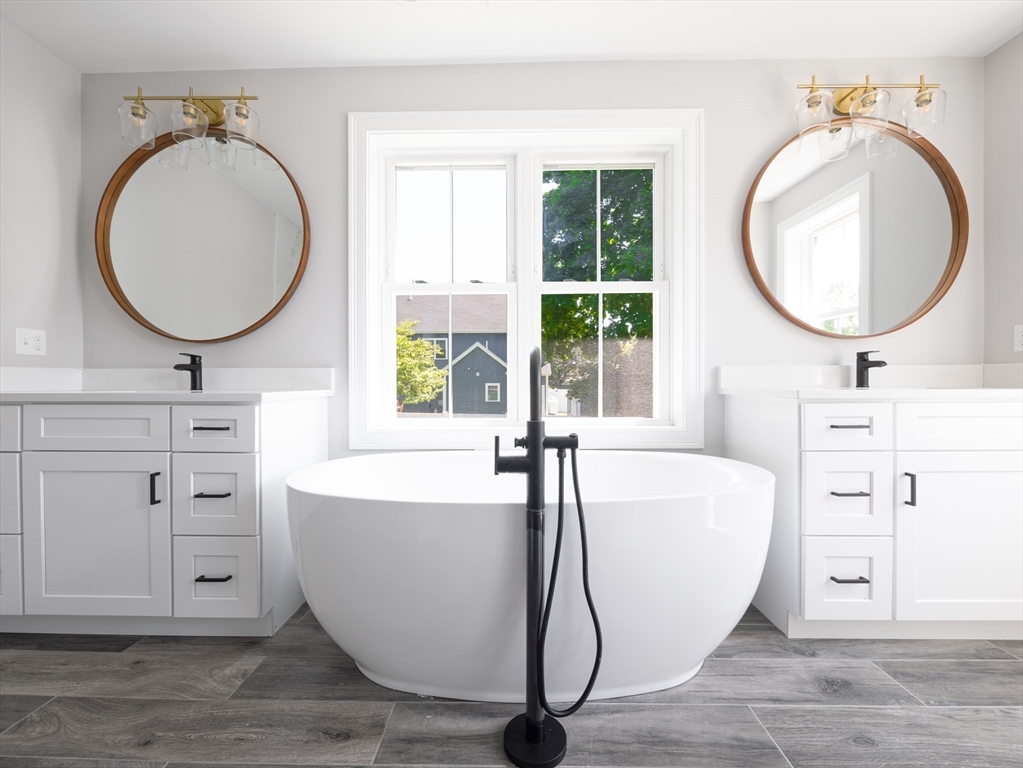 5 Stanley Street Natick, MA 01760 - Photo 9 of 21 a living room with furniture a mirror and a large window