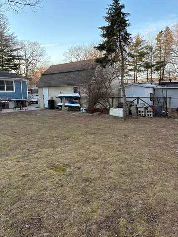 a view of a backyard and a tree