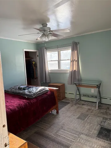 a bedroom with a large bed and a window