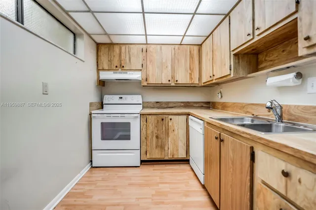 a kitchen with stainless steel appliances granite countertop a sink and cabinets
