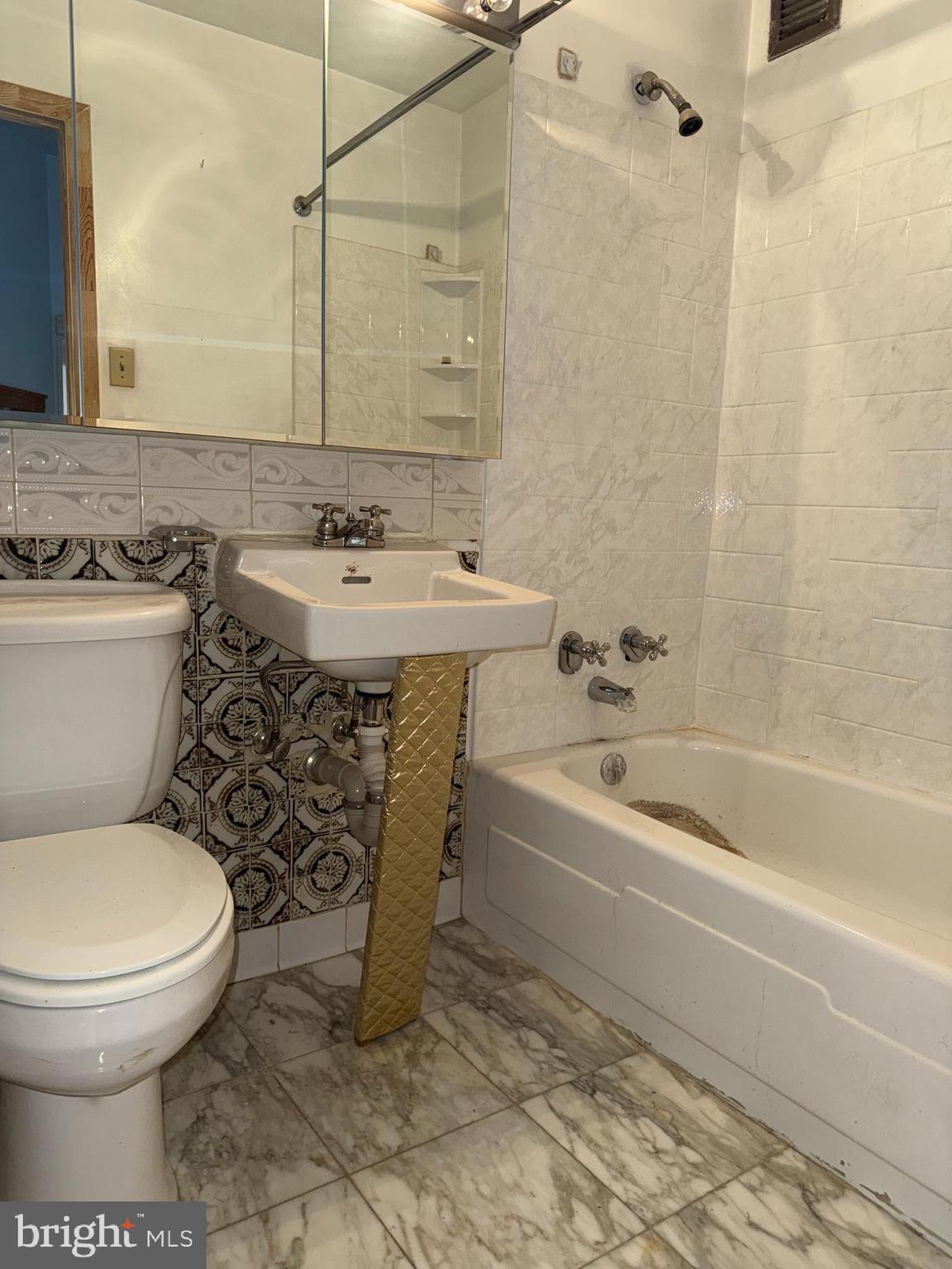 1615 Q Street Northwest, Unit 509 Washington, DC 20009 - Photo 13 of 16 a bathroom with a sink toilet and shower