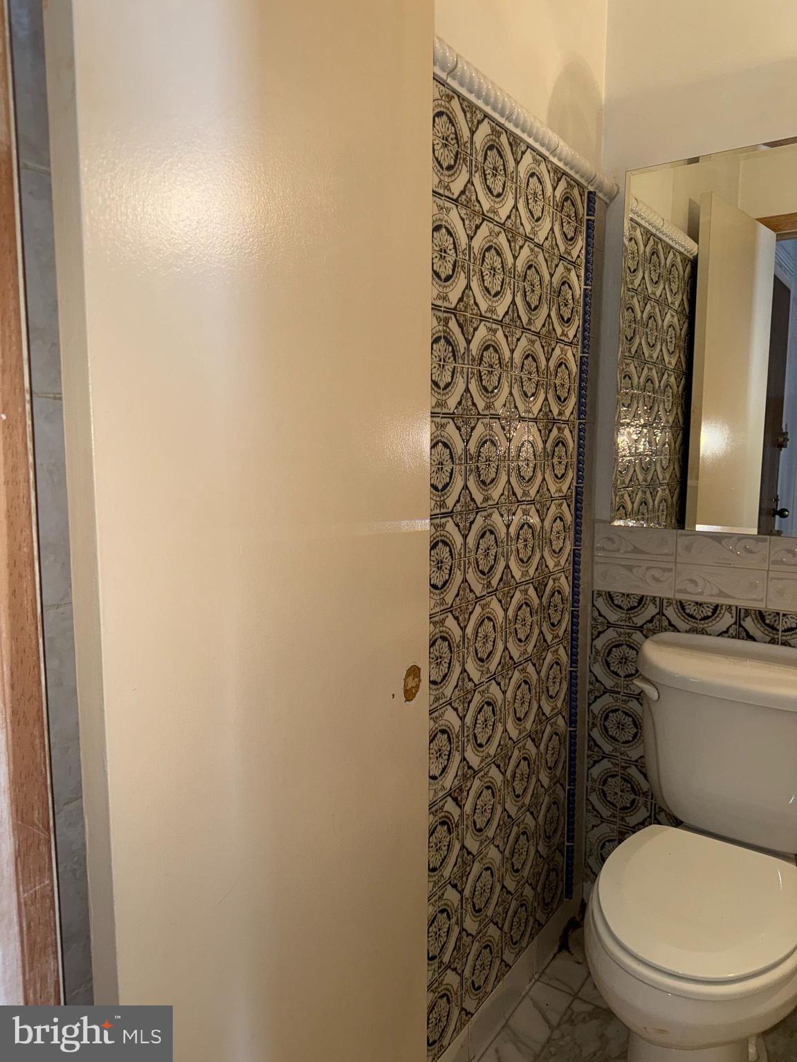 1615 Q Street Northwest, Unit 509 Washington, DC 20009 - Photo 14 of 16 a white toilet sitting next to a shower curtain