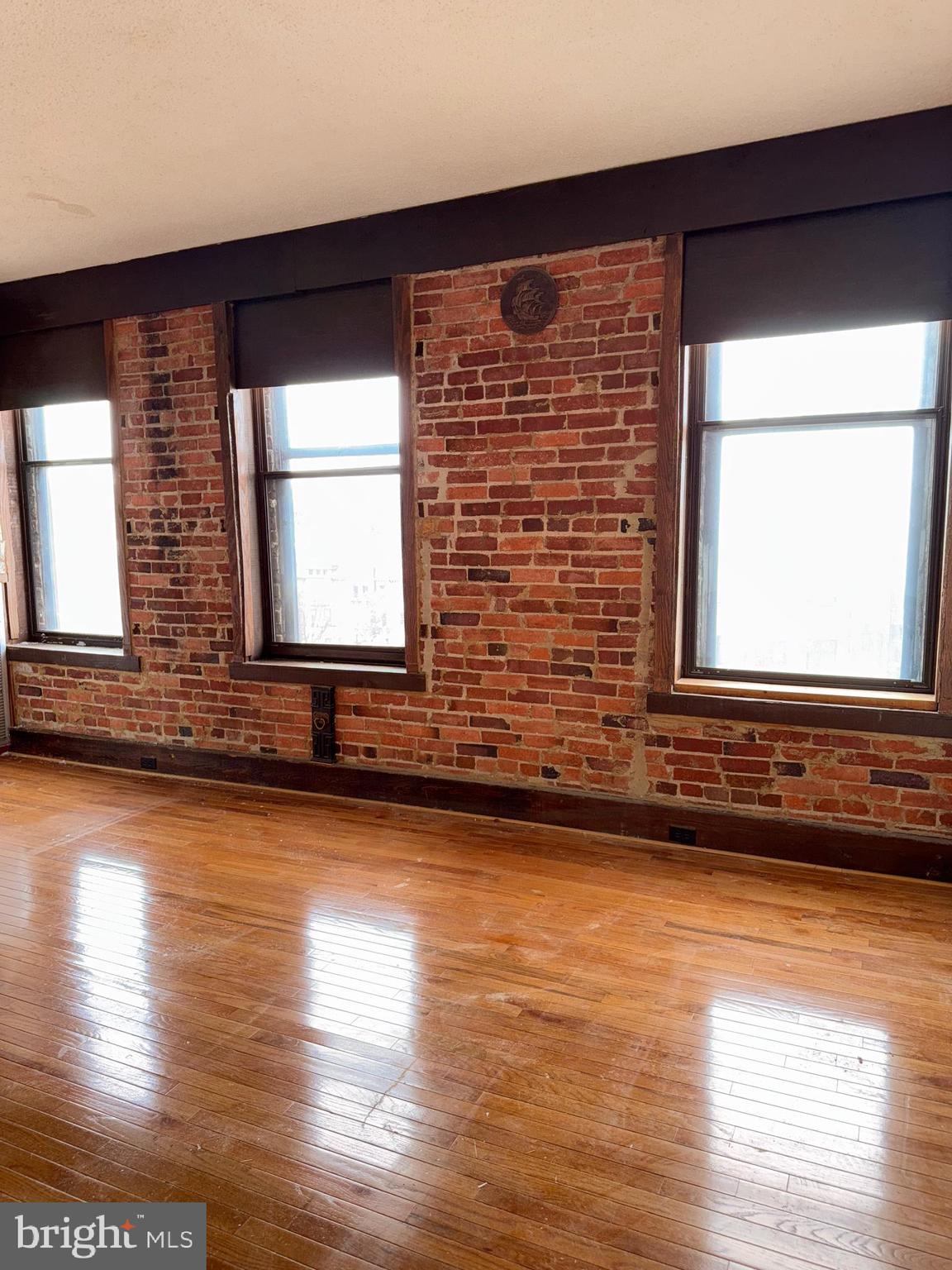 1615 Q Street Northwest, Unit 509 Washington, DC 20009 - Photo 6 of 16 a view of a room with wooden floor and a large window