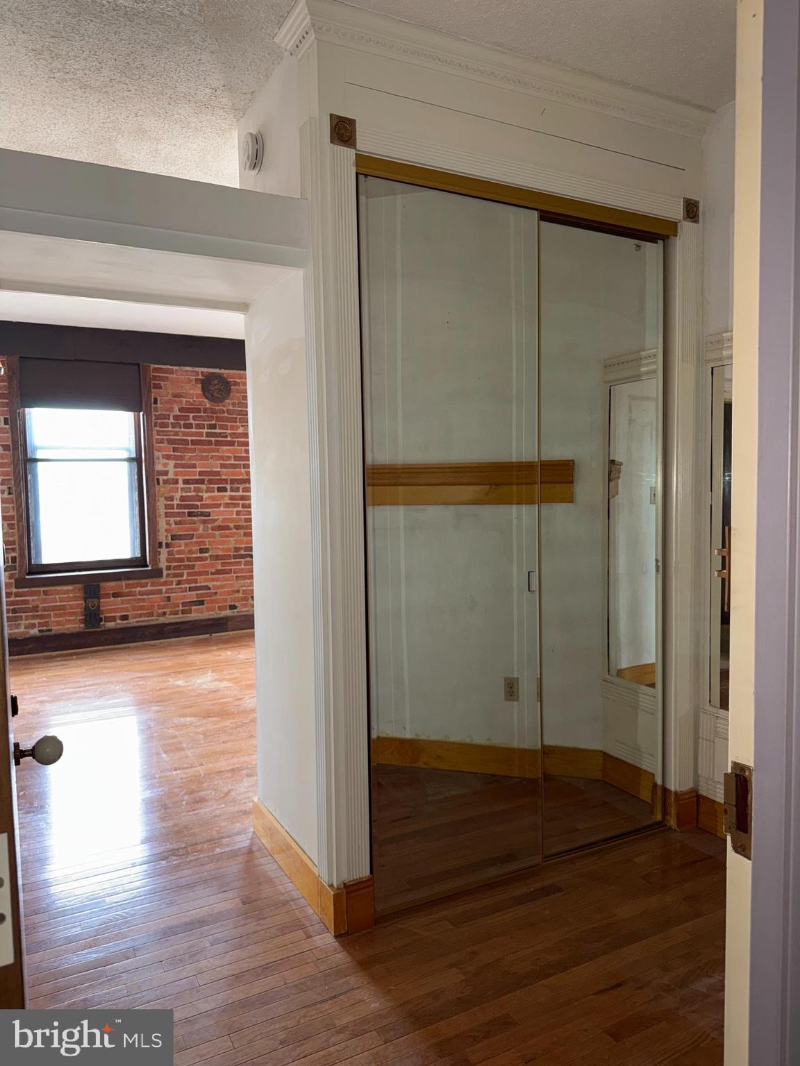 1615 Q Street Northwest, Unit 509 Washington, DC 20009 - Photo 8 of 16 a view of a hallway with wooden floor and cabinet
