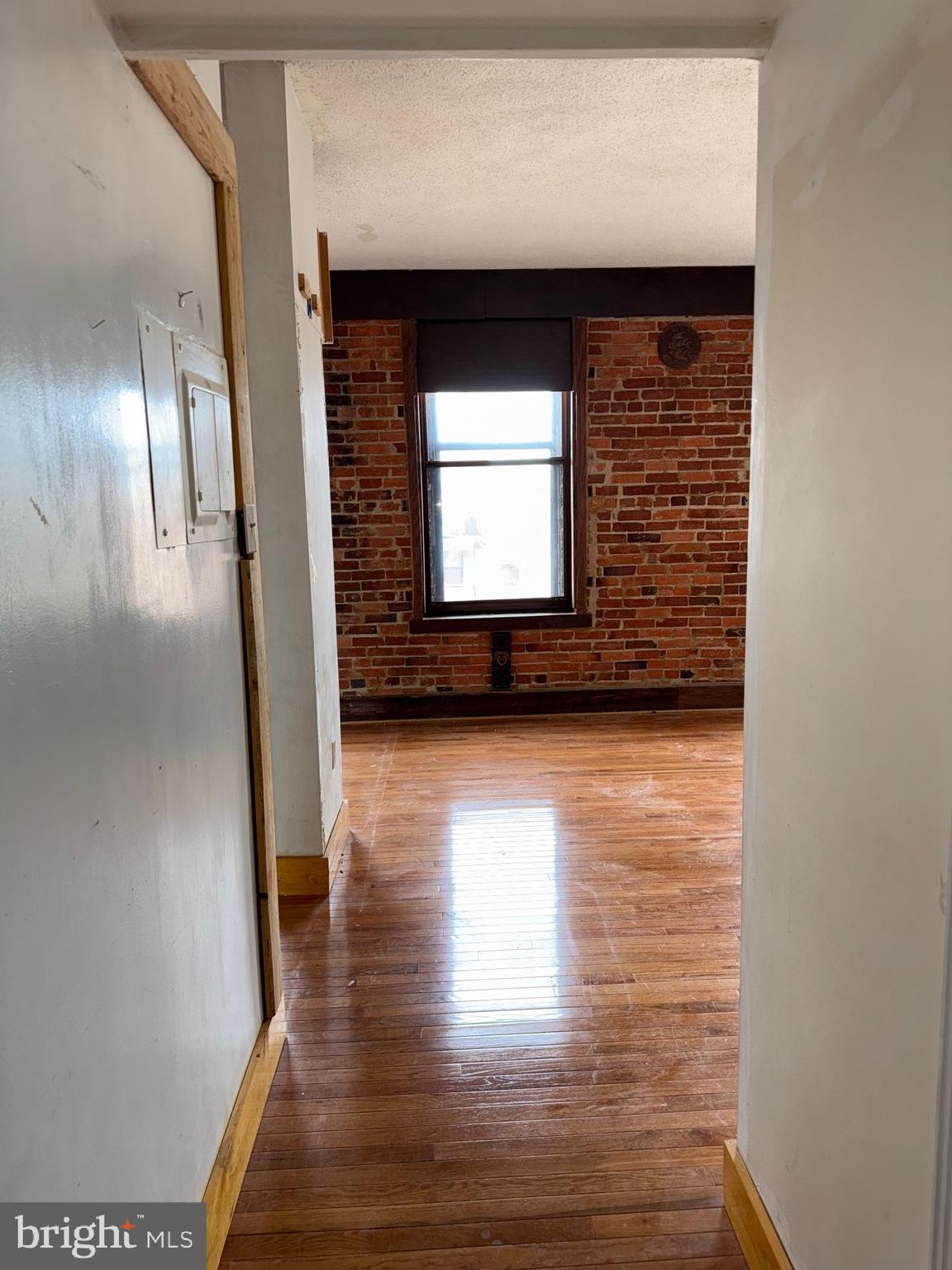 1615 Q Street Northwest, Unit 509 Washington, DC 20009 - Photo 10 of 16 a view of a hallway with wooden floor and a fireplace