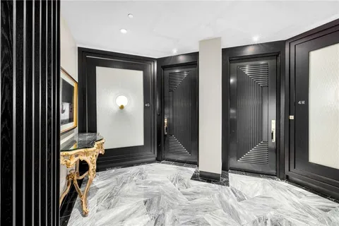 a view of a hallway with wooden shelves