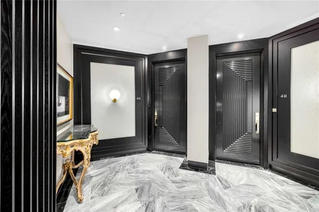 a view of a hallway with wooden shelves