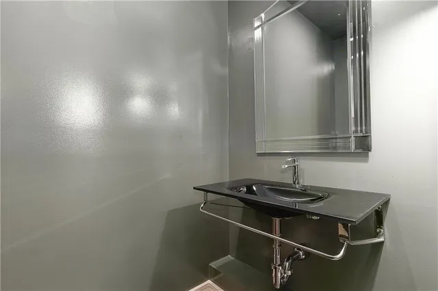 a bedroom with a bed and large window