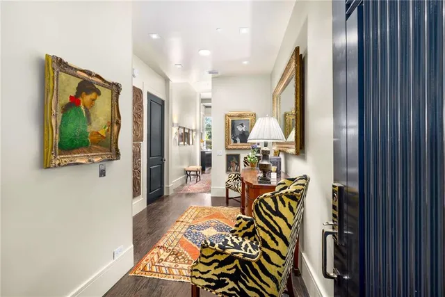 a view of an empty room with wooden floor and closet