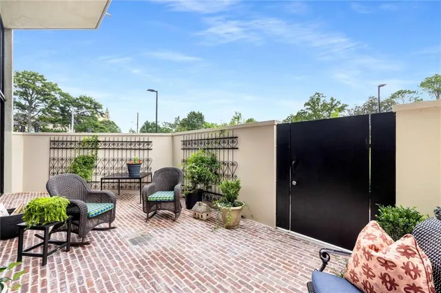 a view of a patio with a dining table and chairs with wooden floor and fence