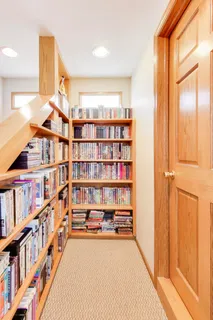 a view of an empty room with a bookshelf