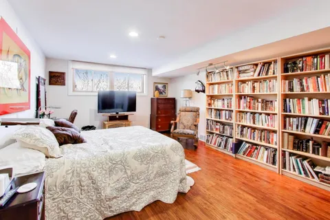 a living room with furniture and a book shelf
