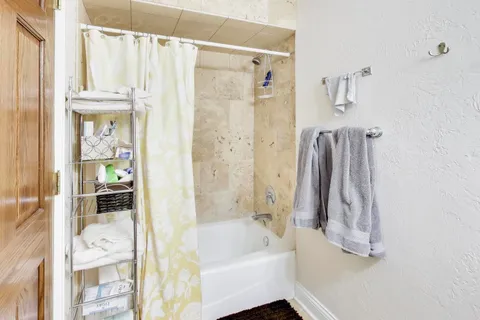 a bathroom with a shower curtain and a sink