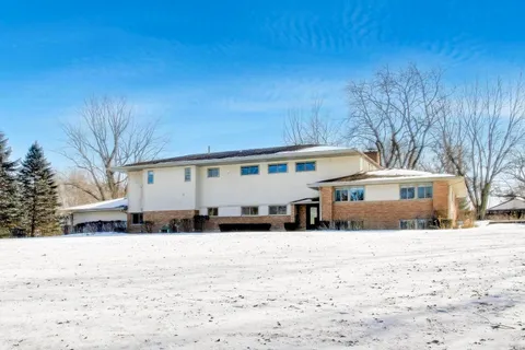 a view of a house with a snow in the yard