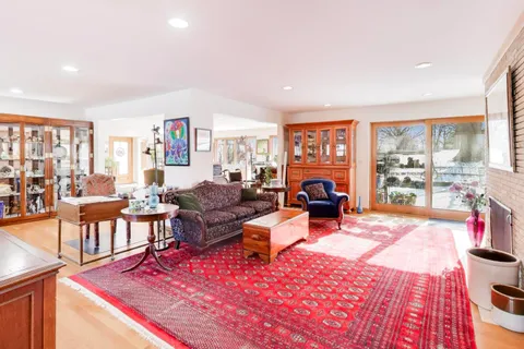 a living room with furniture a rug and a large window