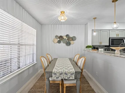 a dining room with furniture and a window