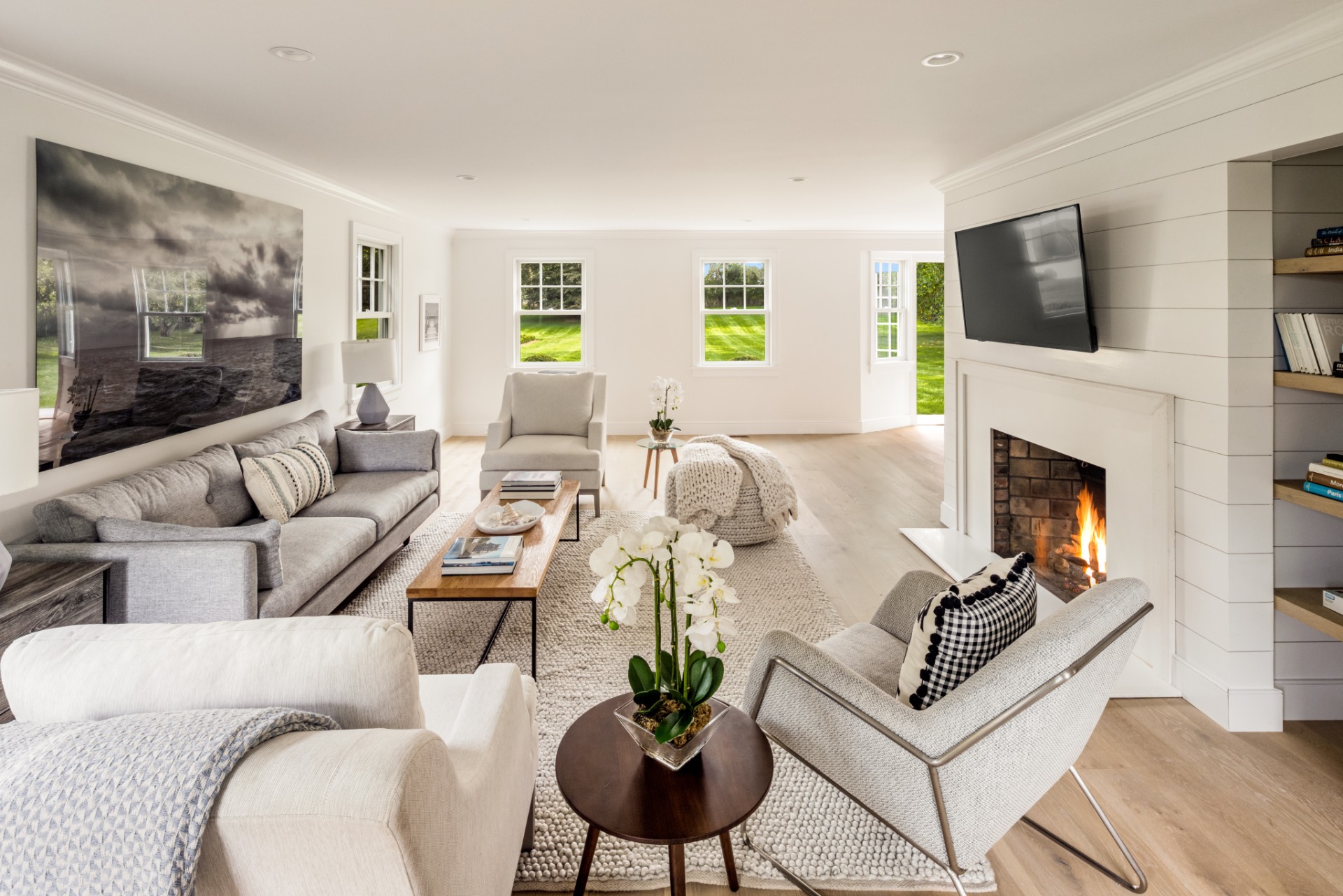 30 Cobb Isle Road Water Mill, NY 11976 - Photo 3 of 10 a living room with furniture a fireplace and a flat screen tv