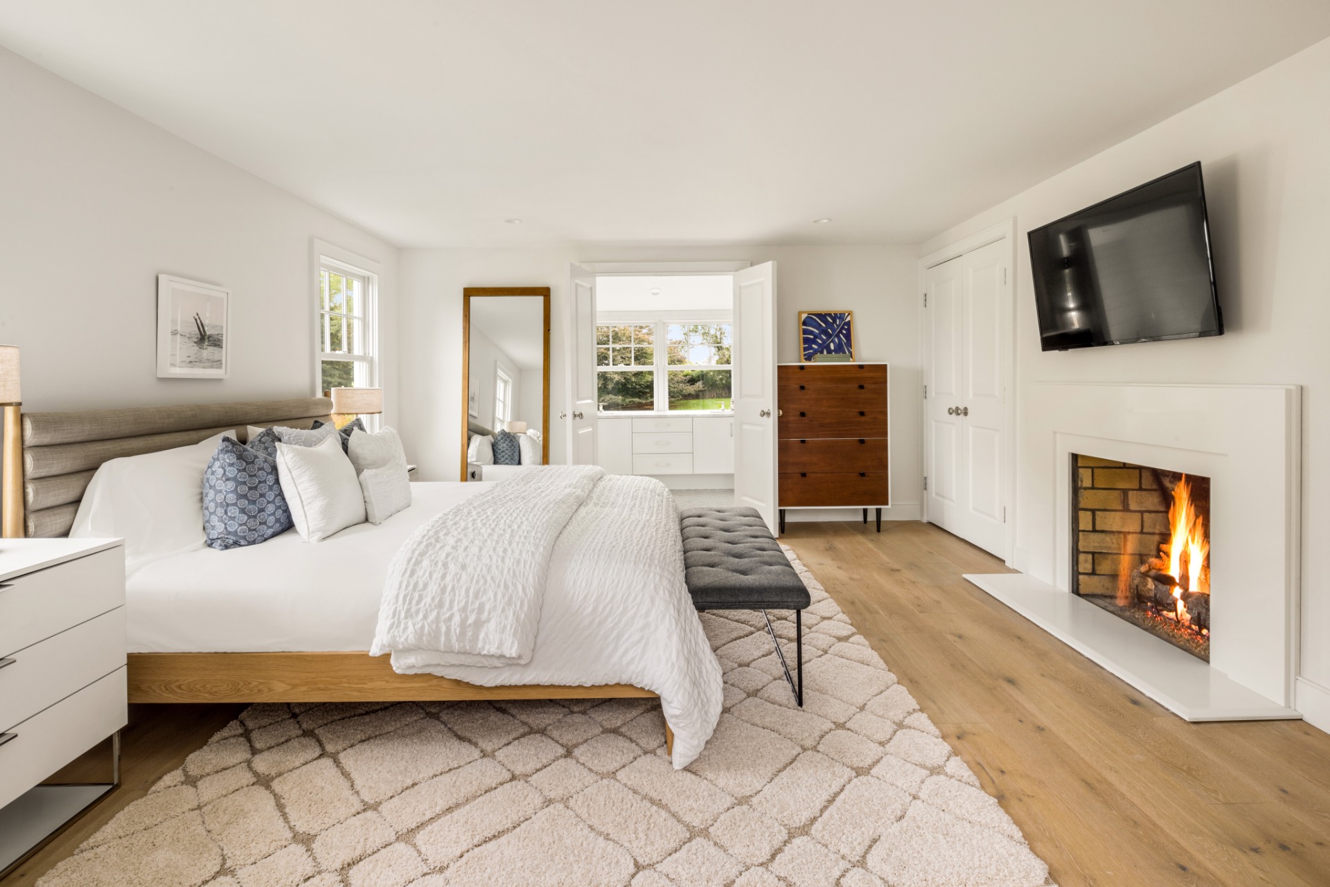 30 Cobb Isle Road Water Mill, NY 11976 - Photo 6 of 10 a spacious bedroom with a bed and a flat screen tv
