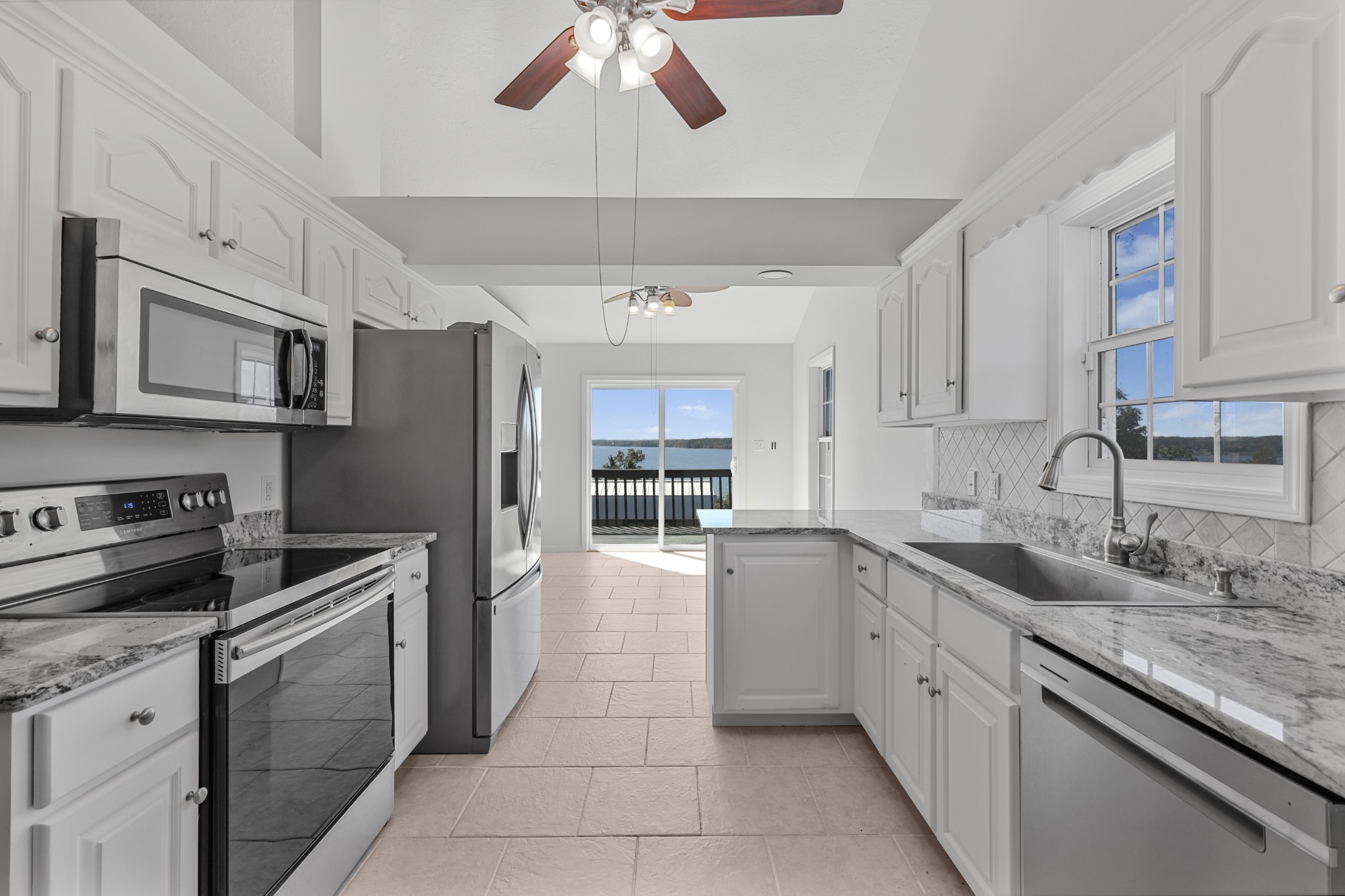 185 Sunset Pass Big Sandy, TN 38221 - Photo 11 of 52 a kitchen with stainless steel appliances granite countertop a sink and cabinets
