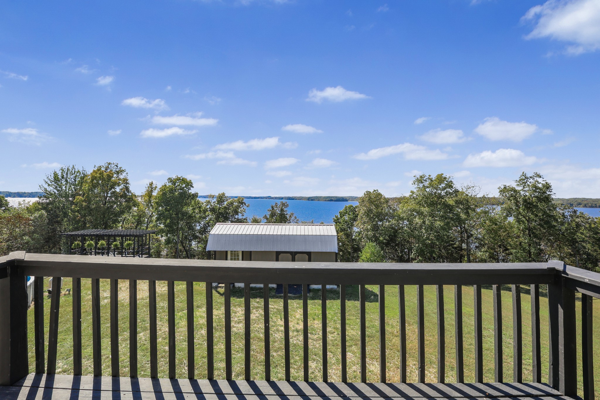185 Sunset Pass Big Sandy, TN 38221 - Photo 16 of 52 a view of a balcony with wooden fence and floor