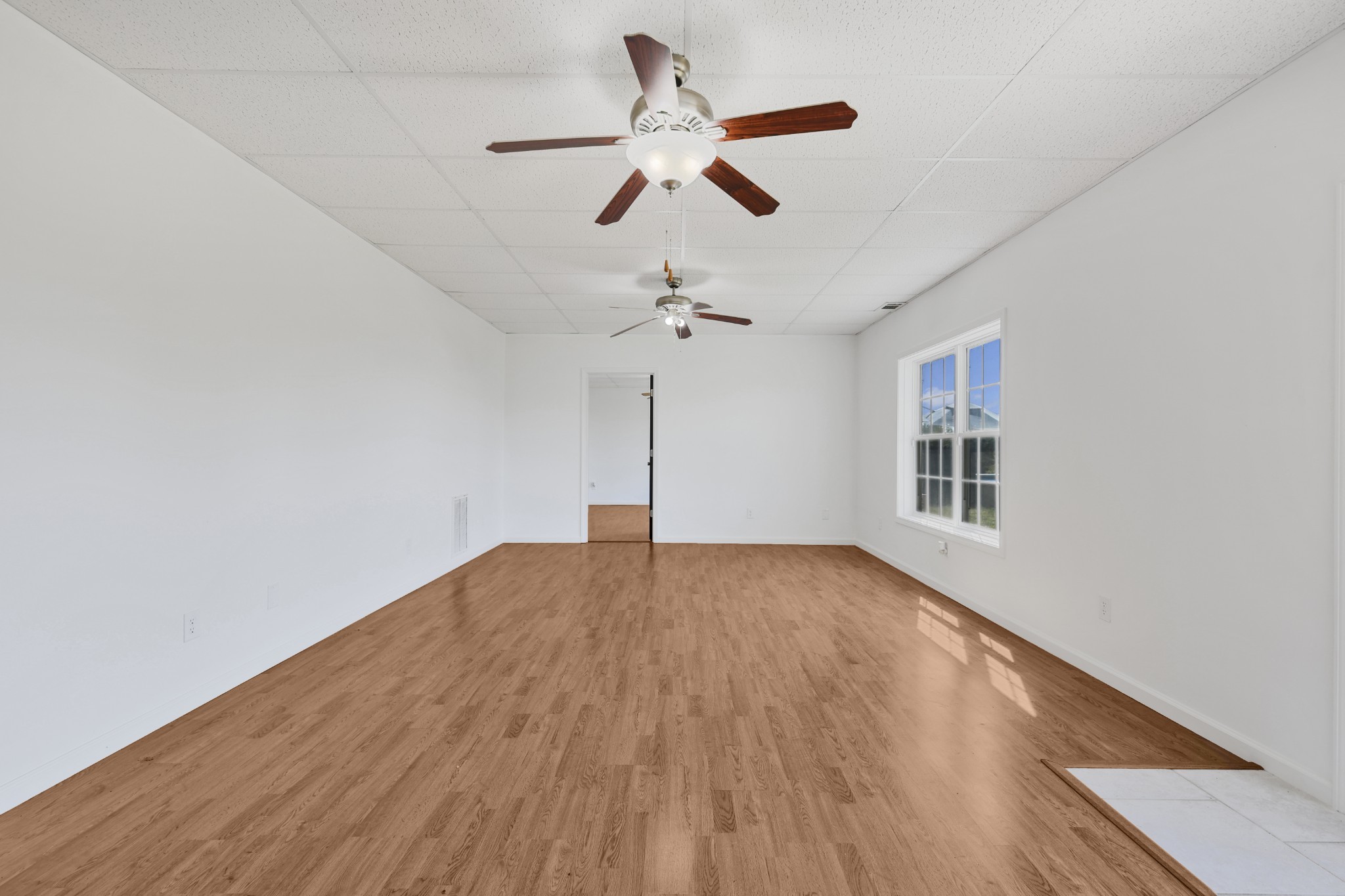 185 Sunset Pass Big Sandy, TN 38221 - Photo 27 of 52 a view of empty room with wooden floor and ceiling fan