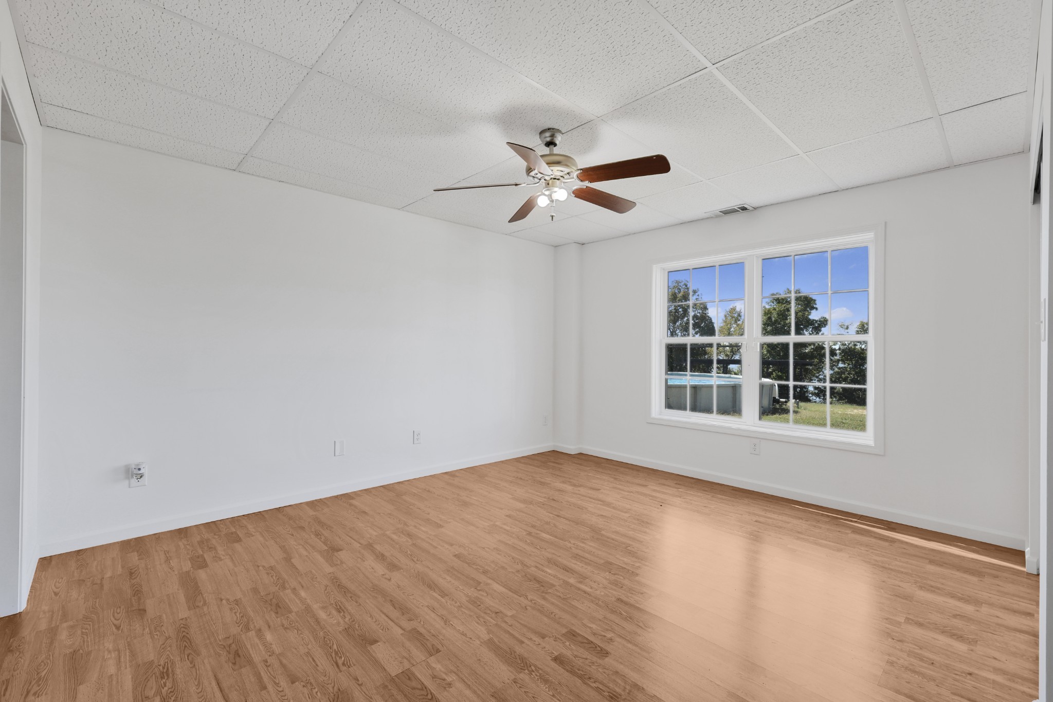 185 Sunset Pass Big Sandy, TN 38221 - Photo 35 of 52 a view of an empty room with a window and kitchen view
