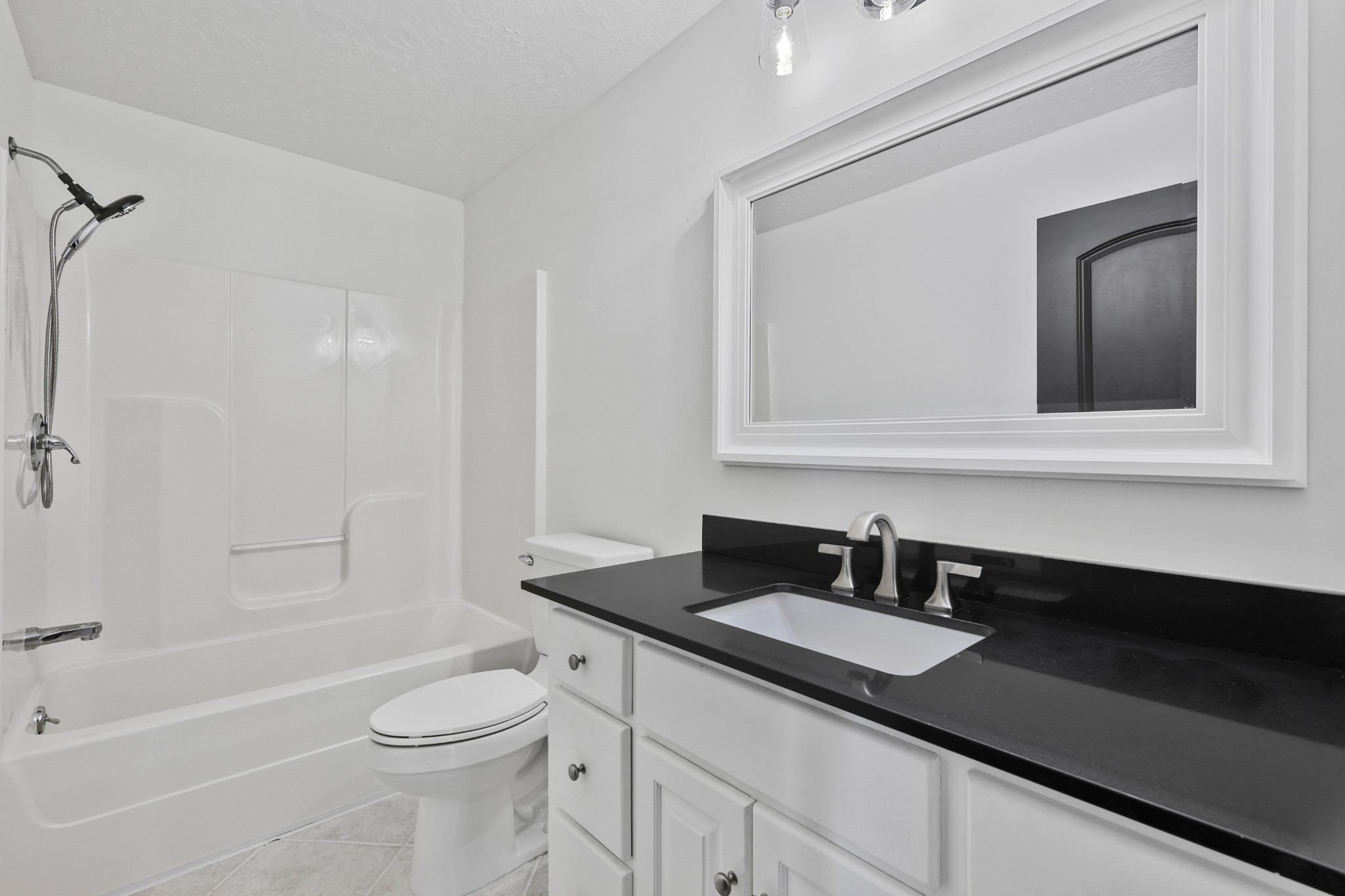 185 Sunset Pass Big Sandy, TN 38221 - Photo 36 of 52 a bathroom with a granite countertop sink a toilet a mirror and shower