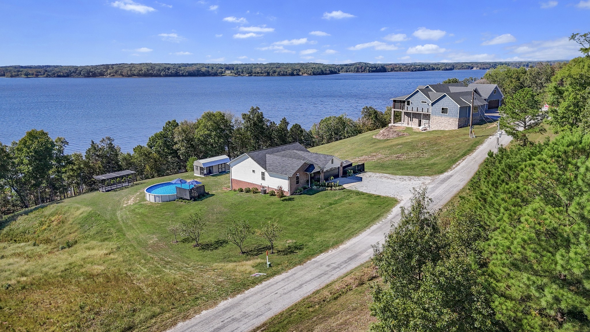 185 Sunset Pass Big Sandy, TN 38221 - Photo 45 of 52 an aerial view of a house with outdoor space and lake view in back