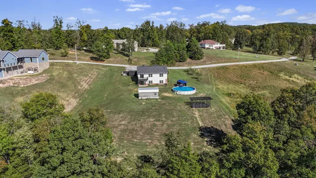 a front view of a house with a yard and lake view