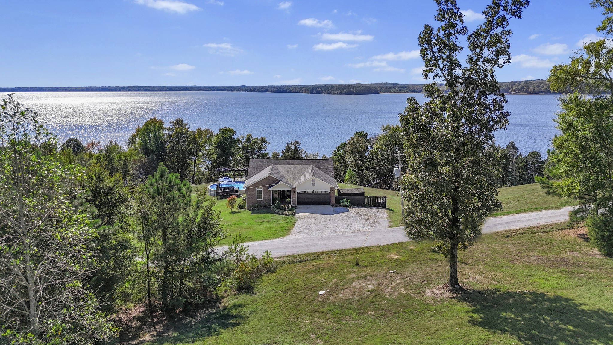 185 Sunset Pass Big Sandy, TN 38221 - Photo 49 of 52 a front view of a house with a yard and lake view