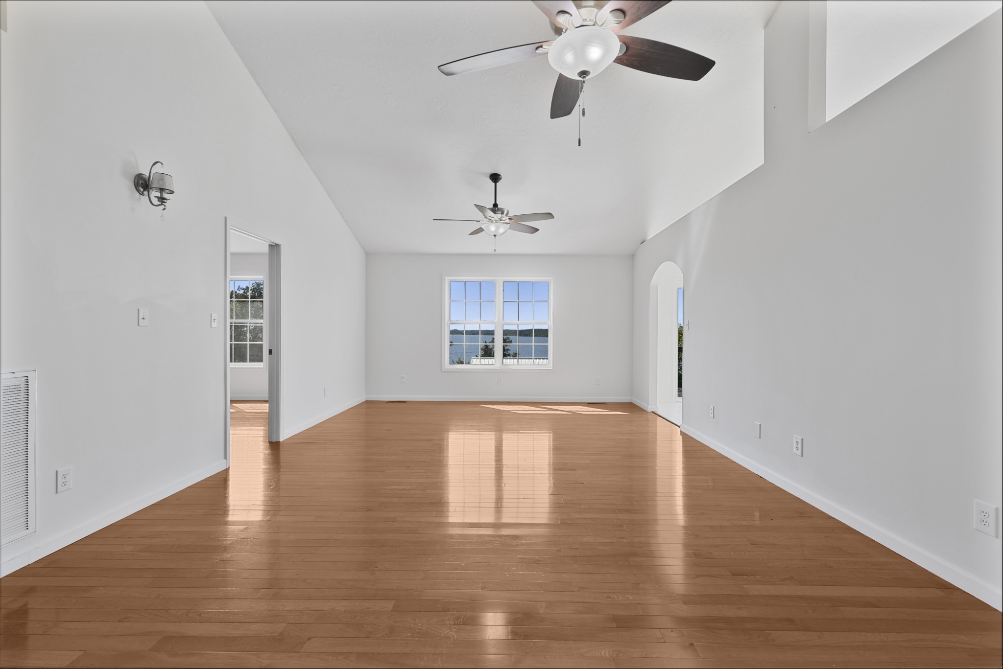 185 Sunset Pass Big Sandy, TN 38221 - Photo 6 of 52 an empty room with wooden floor chandelier fan and windows