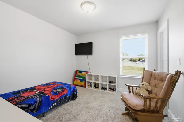 a bedroom with furniture and a window
