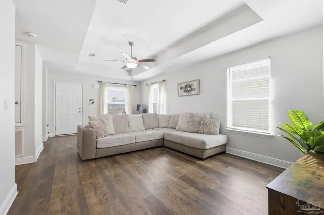a living room with furniture and wooden floor