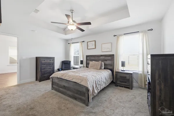 a bedroom with a bed dresser and a window