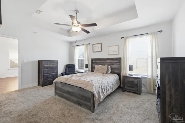 a bedroom with a bed dresser and a window