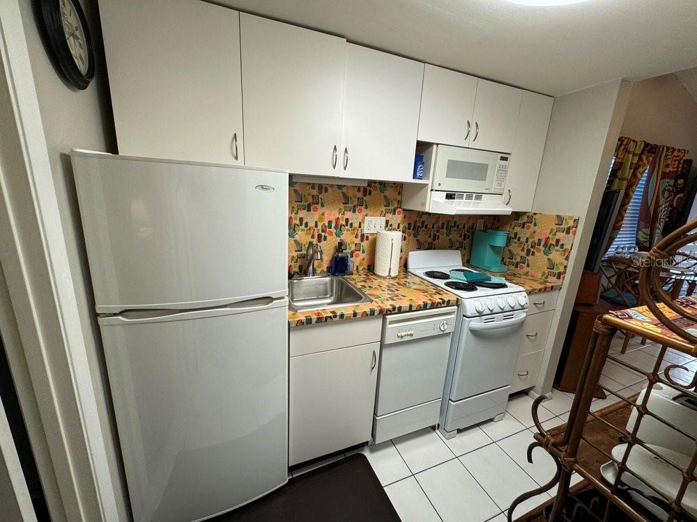 1865 Mazo Manor Road, Unit J2 Lutz, FL 33558 - Photo 10 of 12 a white refrigerator freezer sitting inside of a kitchen