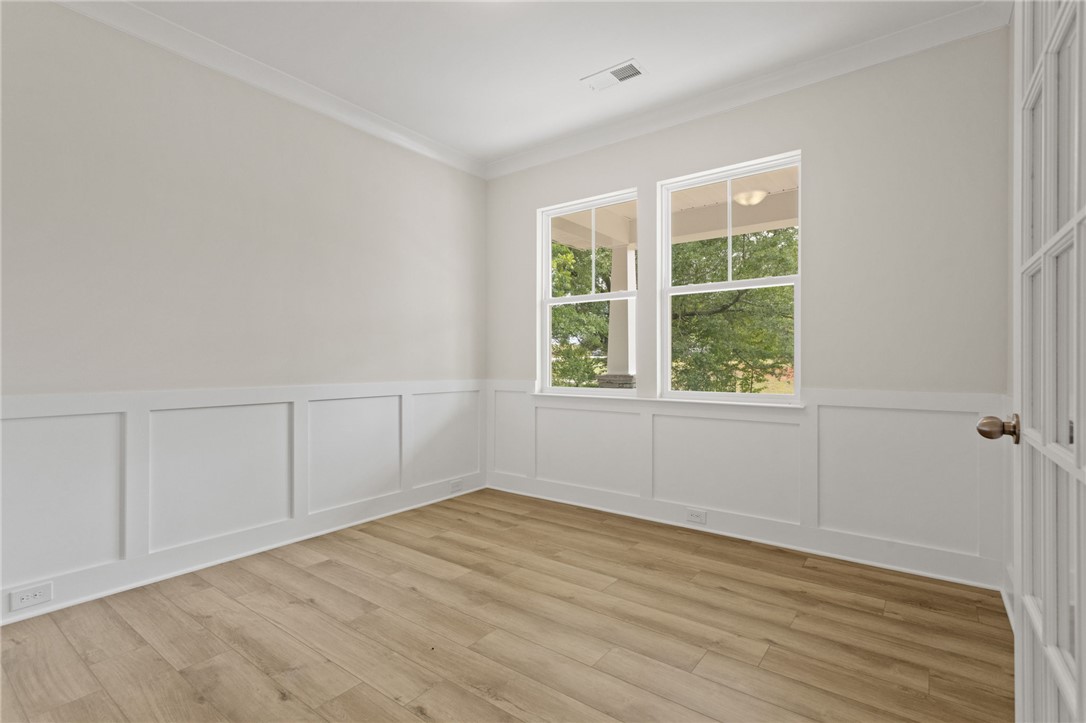315 Old Shirley Road Central, SC 29630 - Photo 5 of 26 This bright room features elegant paneling and durable flooring, offering a versatile space.